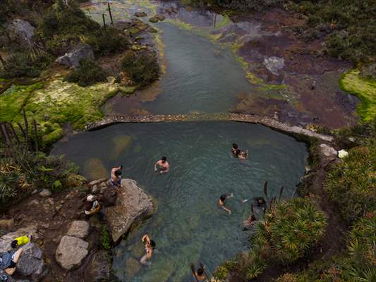 Tourists ascend to the hot springs lagoons of the Nevado del Rui