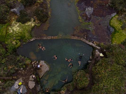 Tourists ascend to the hot springs lagoons of the Nevado del Rui