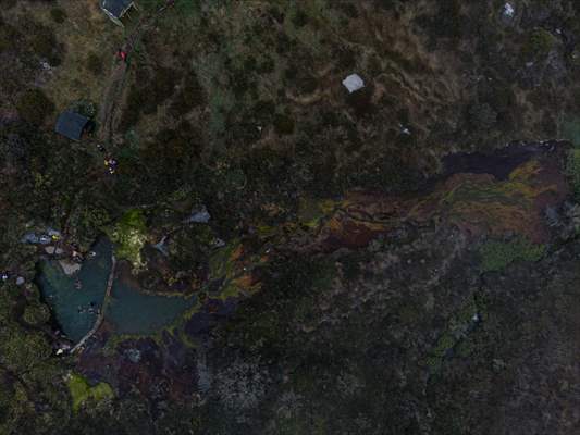 Tourists ascend to the hot springs lagoons of the Nevado del Rui