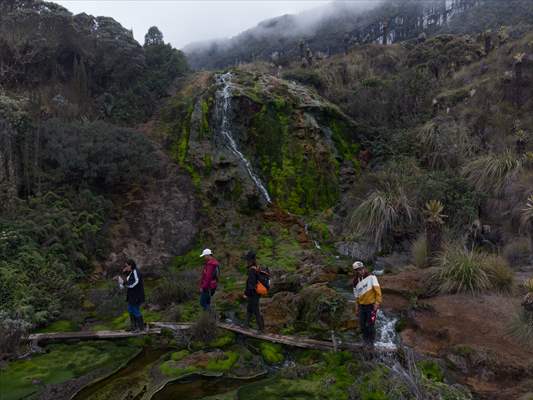 Tourists ascend to the hot springs lagoons of the Nevado del Rui