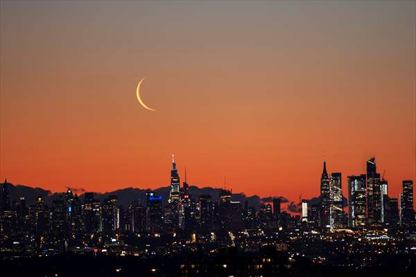 Crescent moon rises over New York City