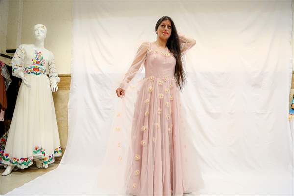 Acid attack victims model for Iranian fashion designer
