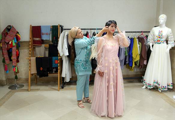 Acid attack victims model for Iranian fashion designer