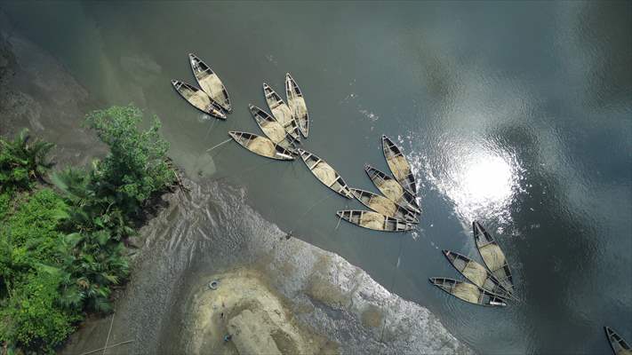 Cameroonian young people work under Sanaga River