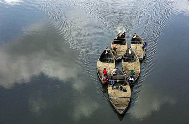 Cameroonian young people work under Sanaga River