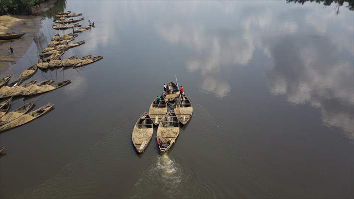 Cameroonian young people work under Sanaga River