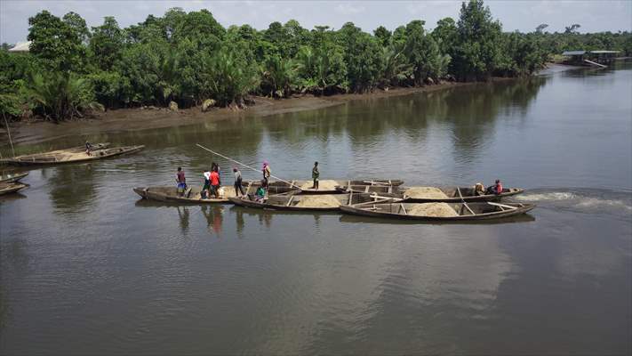 Cameroonian young people work under Sanaga River