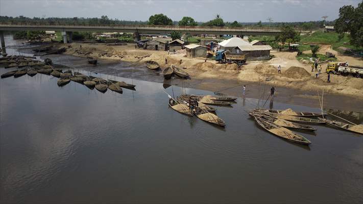 Cameroonian young people work under Sanaga River