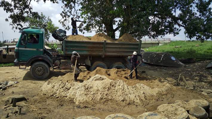 Cameroonian young people work under Sanaga River