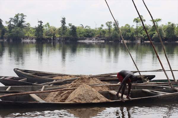 Cameroonian young people work under Sanaga River