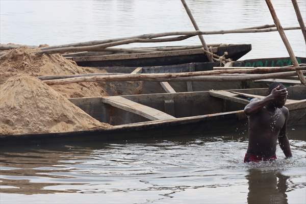 Cameroonian young people work under Sanaga River