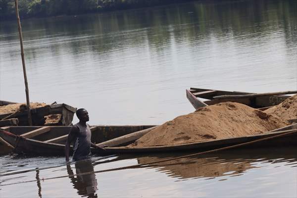 Cameroonian young people work under Sanaga River