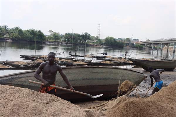 Cameroonian young people work under Sanaga River