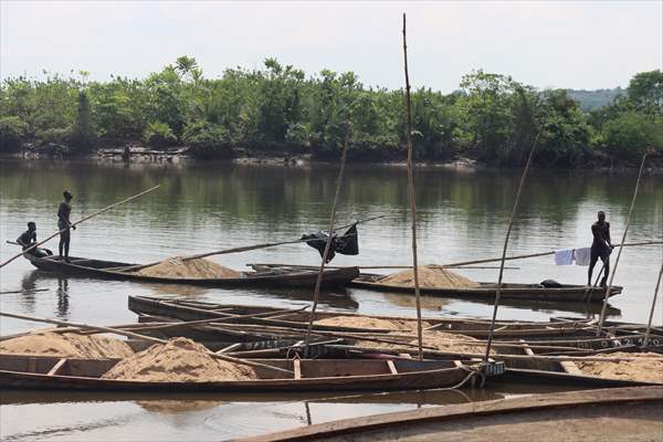 Cameroonian young people work under Sanaga River