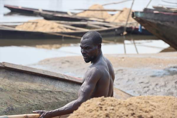 Cameroonian young people work under Sanaga River