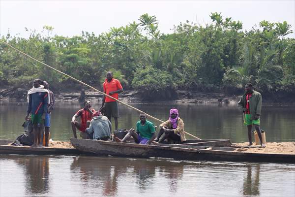 Cameroonian young people work under Sanaga River