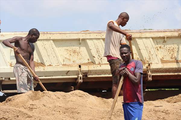 Cameroonian young people work under Sanaga River