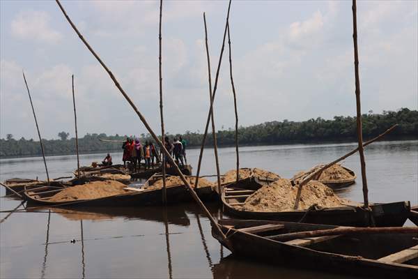 Cameroonian young people work under Sanaga River