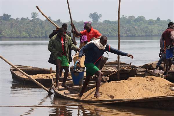 Cameroonian young people work under Sanaga River