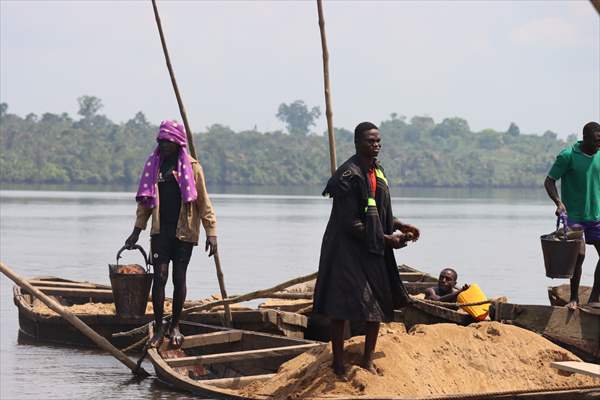 Cameroonian young people work under Sanaga River