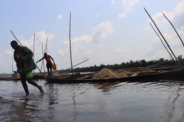 Cameroonian young people work under Sanaga River