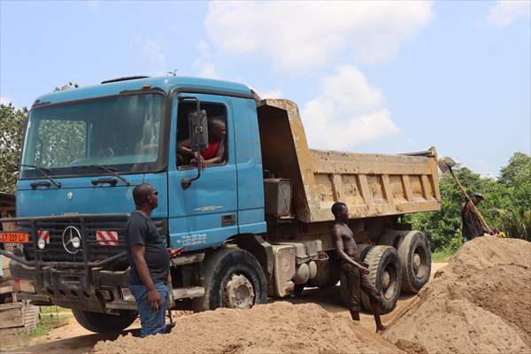 Cameroonian young people work under Sanaga River