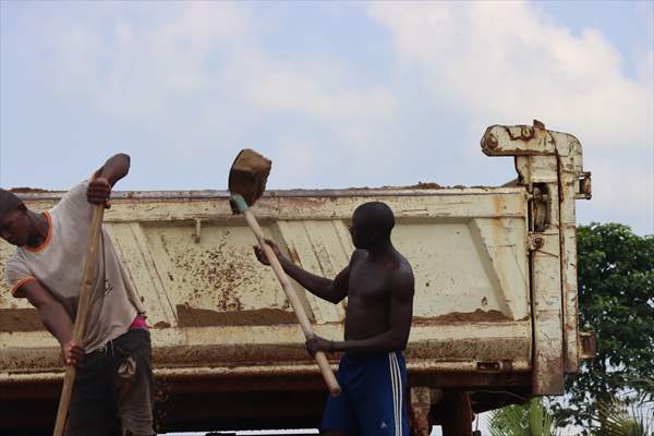 Cameroonian young people work under Sanaga River