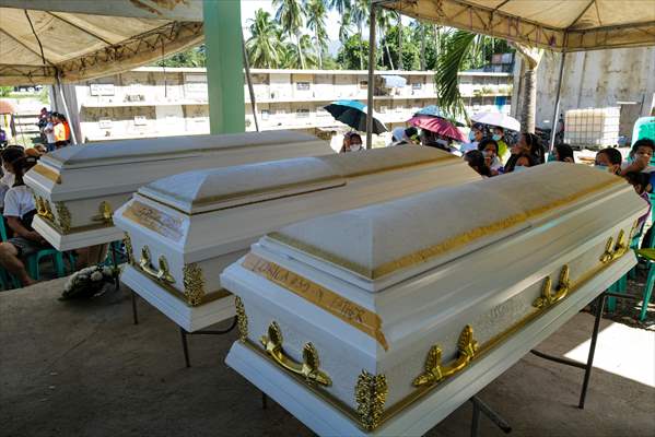 Mass burial ceremony for landslide victims in Philippines