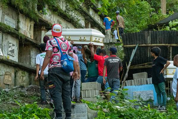 Mass burial ceremony for landslide victims in Philippines