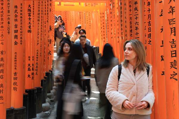 Fushimi Inari Shrine in Kyoto welcomes tourists and locals, reflecting daily life