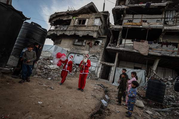 Volunteers dressed as Santa bring joy to children in Gaza