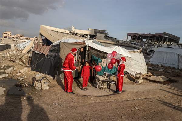 Volunteers dressed as Santa bring joy to children in Gaza