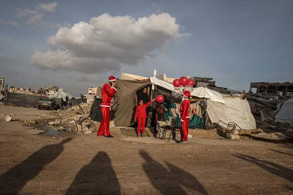 Volunteers dressed as Santa bring joy to children in Gaza