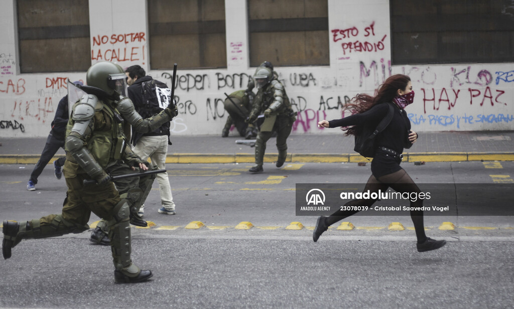 Protester running away from the police in Chile’s Concepcion