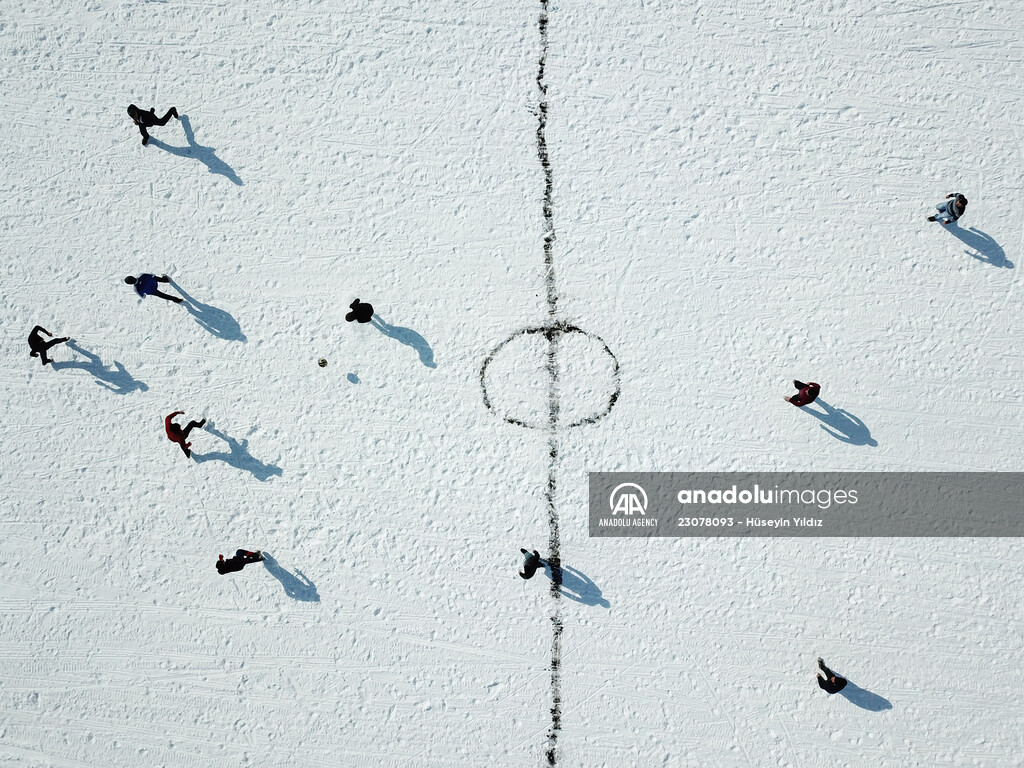 Football on ice-covered lake