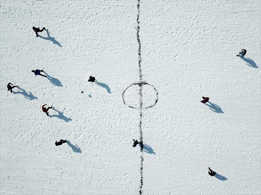 Football on ice-covered lake